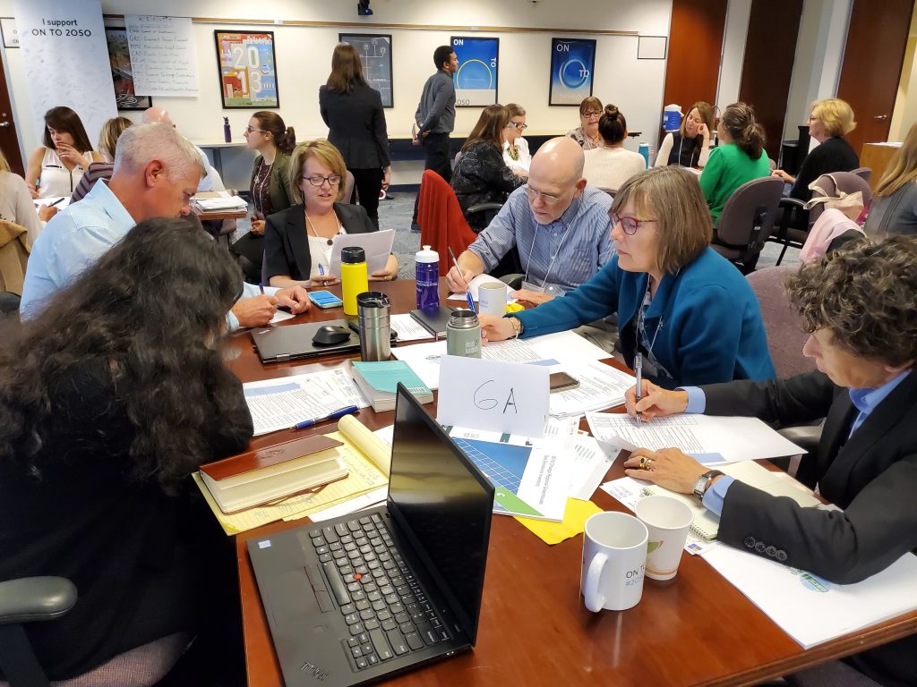 Groups work on a regional climate planning activity at a Metropolitan Mayors Caucus Environment Committee meeting in October of 2019.