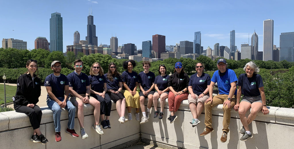 The GRCorps sits on a ledge in Chicago, with the Chicago skyline in the background.